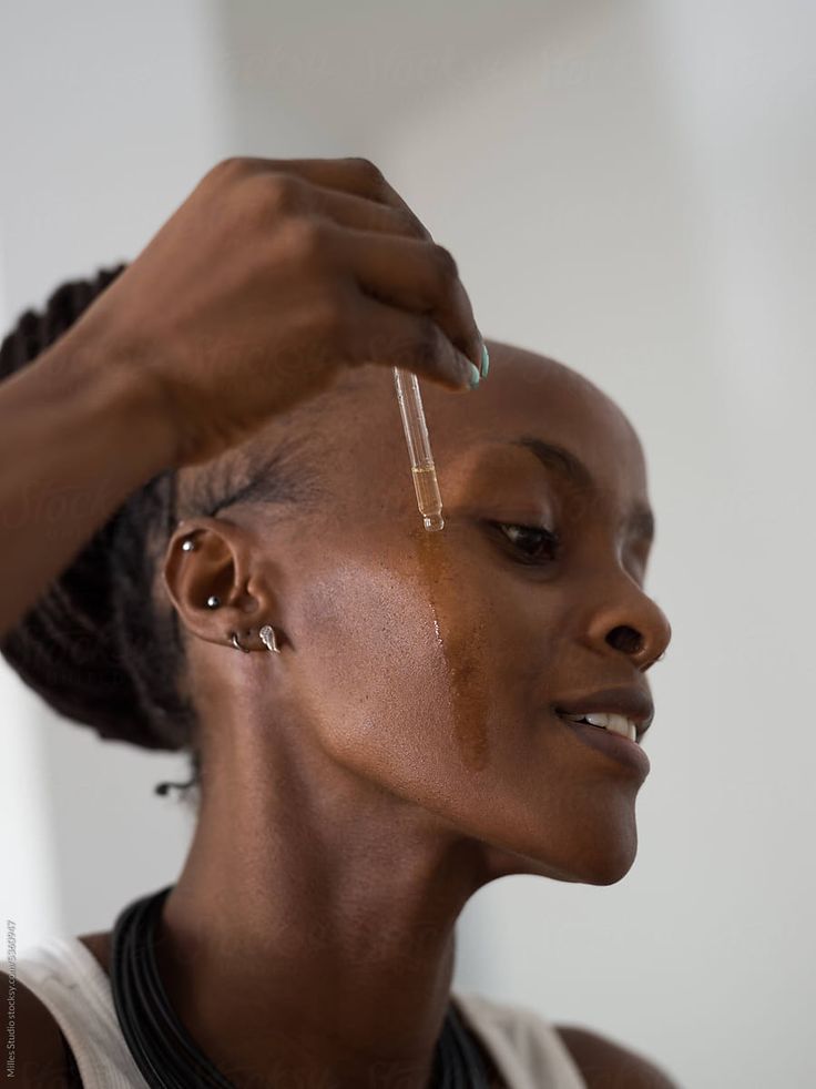 Smiling women applying serum