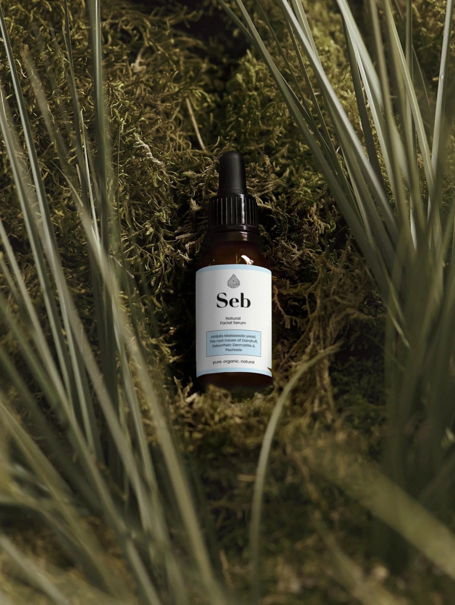 Seb Calming Serum bottle placed in natural setting, emphasising soothing properties for eczema and seborrheic dermatitis.