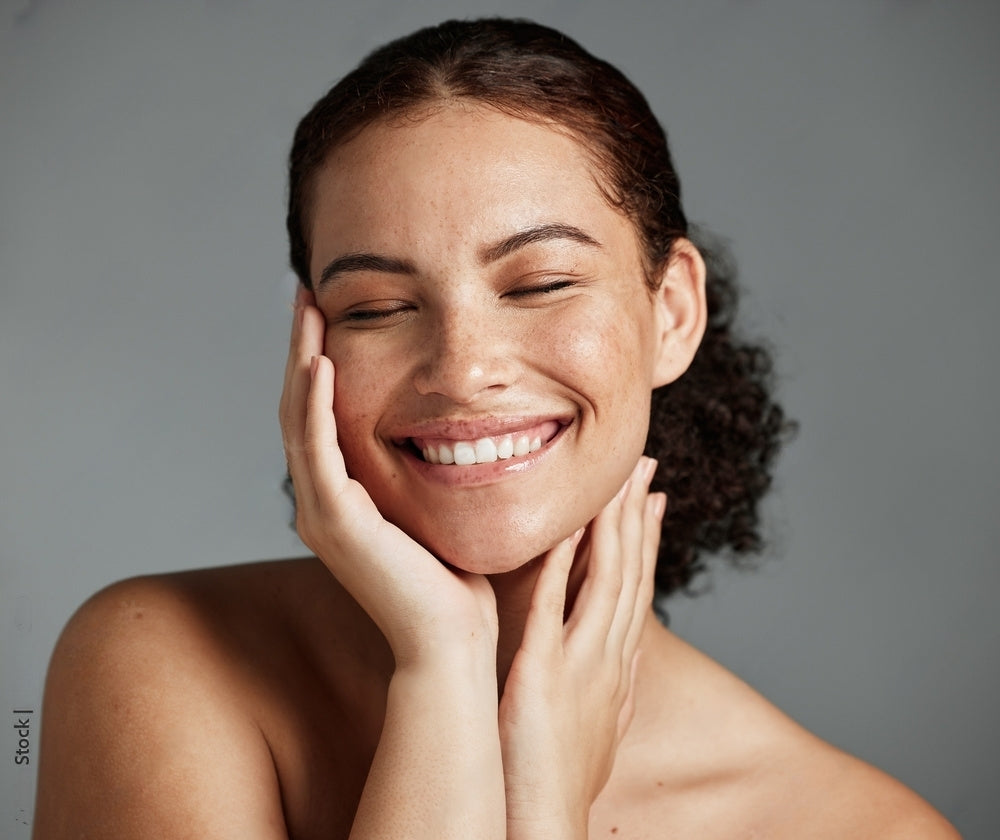 Smiling model with glowing skin, showcasing the calming effects of Seb Calming Serum for eczema and seborrheic dermatitis.